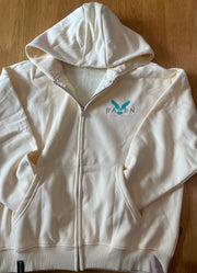 A beige Tiki Tide zip hoodie with the brand logo visible on the front.