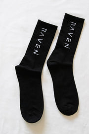 Pair of Black socks with 'Raven' text
