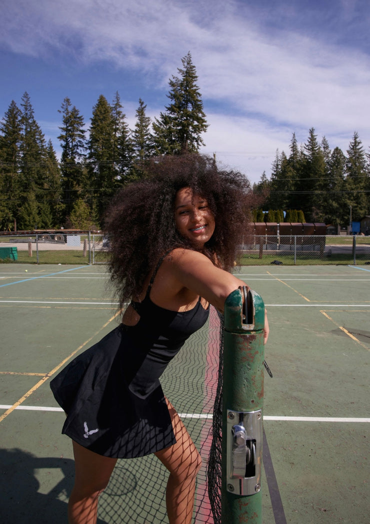 black tennis dress white logo model posed