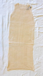 This image displays a swim coverup with a stylish and breathable design, ideal for beach or poolside wear. The coverup features a beige color and is crafted from a textured fabric, likely a cotton blend, which adds a comfortable, lightweight feel.