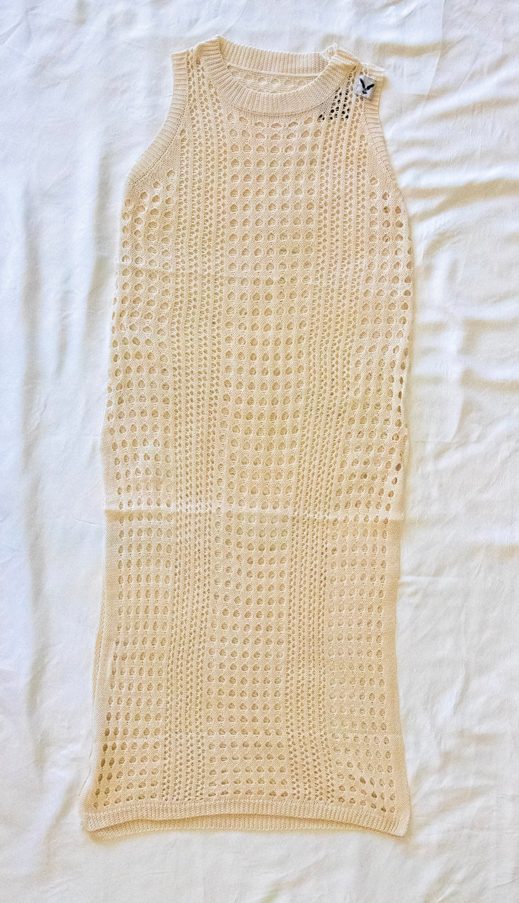 This image displays a swim coverup with a stylish and breathable design, ideal for beach or poolside wear. The coverup features a beige color and is crafted from a textured fabric, likely a cotton blend, which adds a comfortable, lightweight feel.