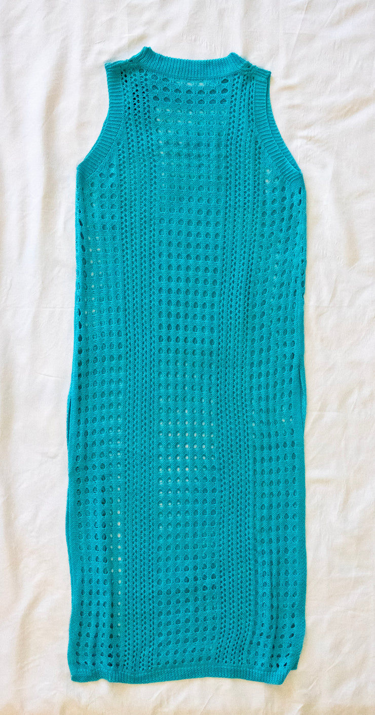 front of teal crochet dress / bathing suit cover on a white textured 